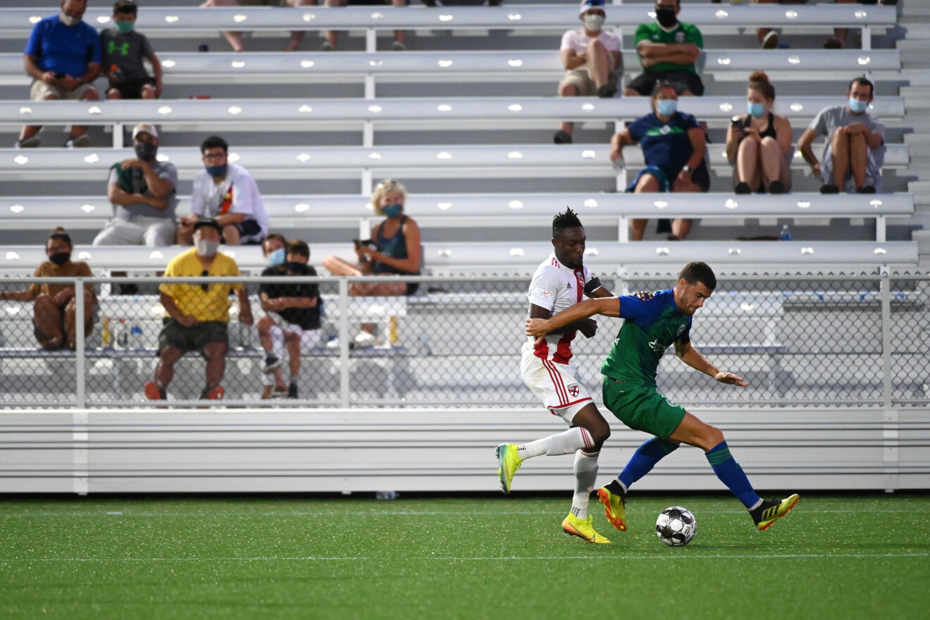 Defender Alex Davey of Hartford Athletic and forward Elvis Amoh of Loudoun United FC wrestle for the ball in the second half. Athletic won 3-1.